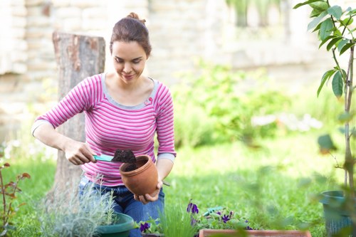 Landscaper maintaining a lush garden in Uxbridge